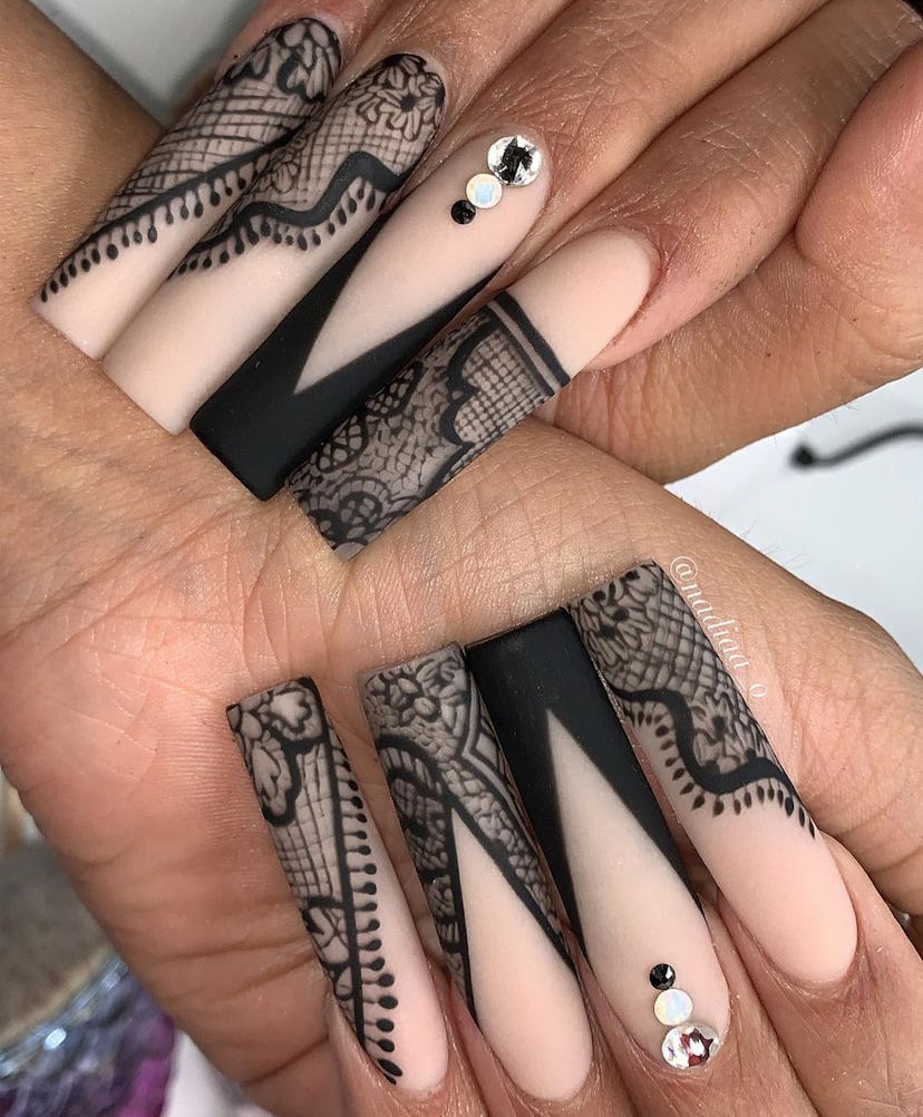 V-shaped nails with black lace designs are on-trend.