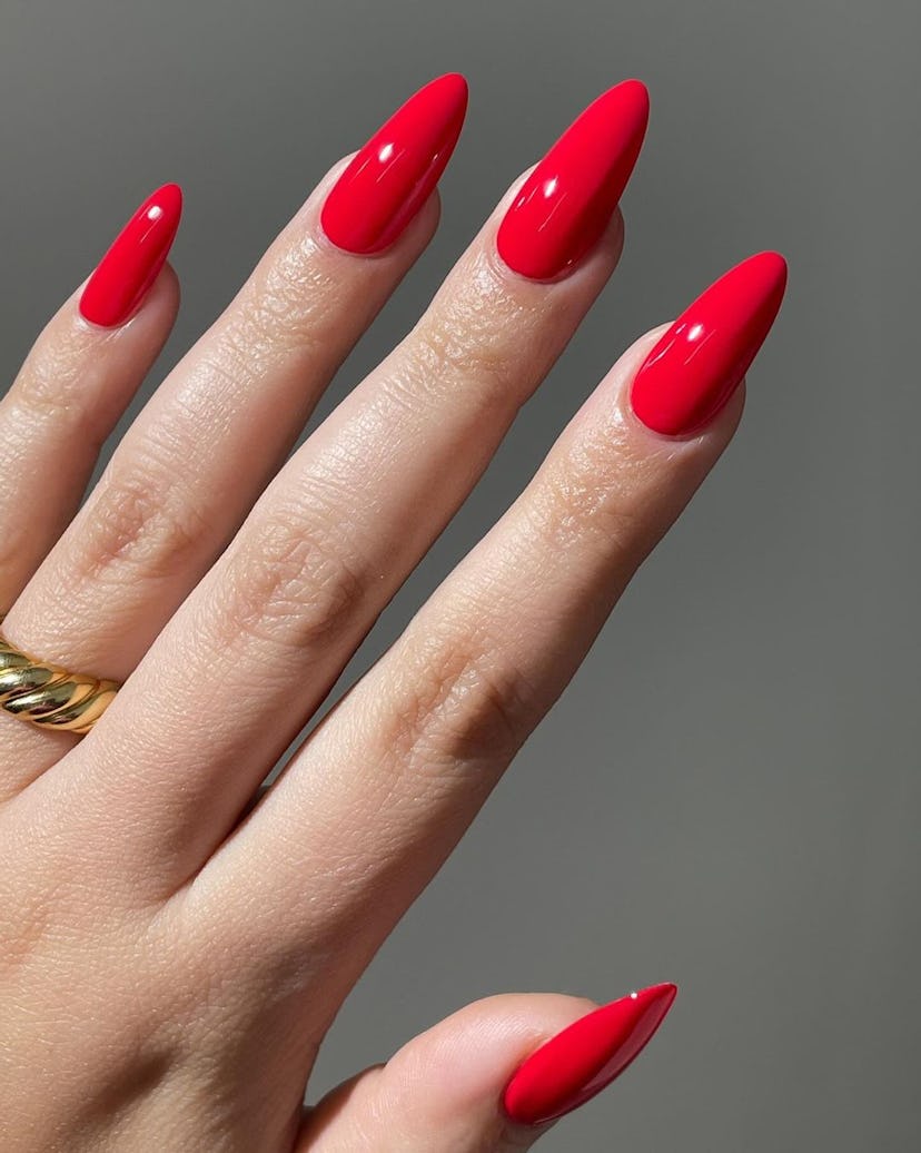Bright red is an on-trend nail polish color for spring 2024.