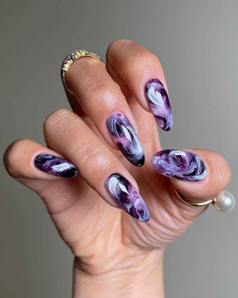 Dark purple watercolor nails are on-trend for Pisces season 2024.