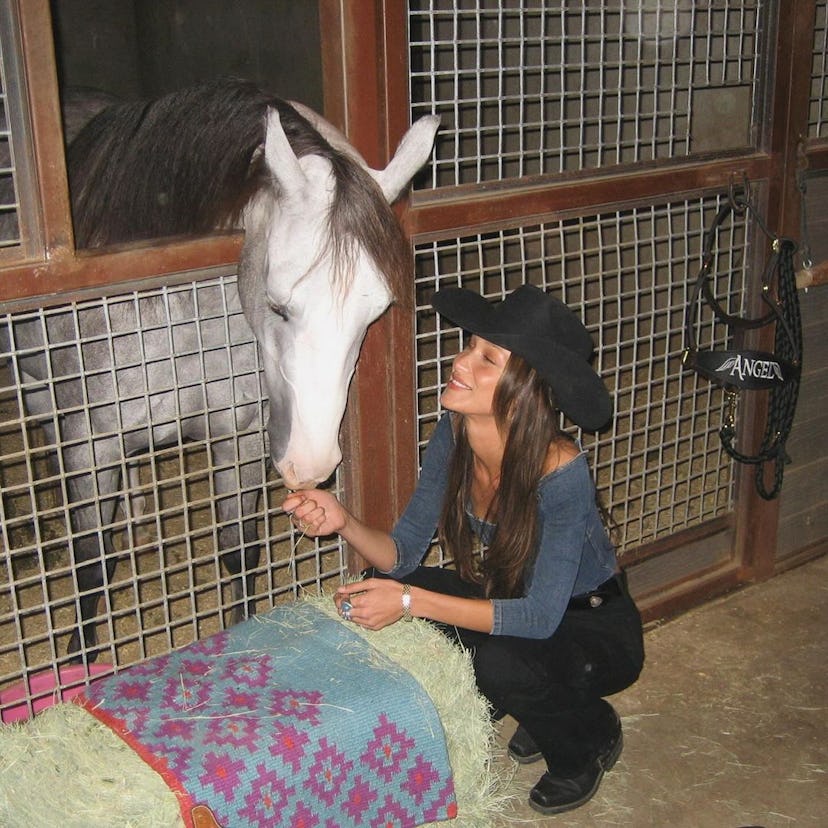Bella Hadid with a horse