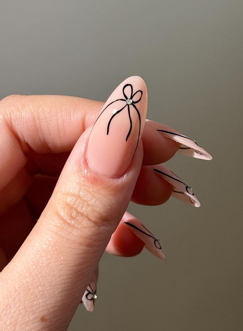 Neutral nails with ribbon French tip details are on-trend for Pisces season 2024.