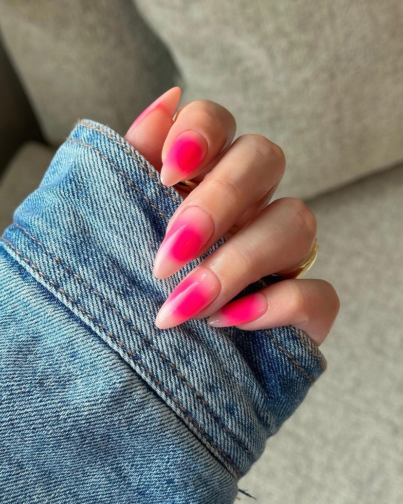 Neon pink aura nails are on-trend for 2024.