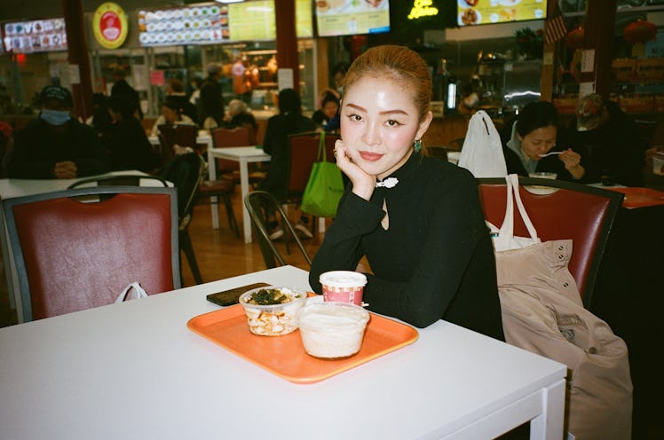 Zoey Gong seated at a restaurant table. 