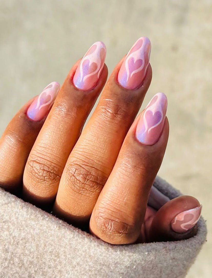Pink holographic nails with flame designs are on-trend for 2024.