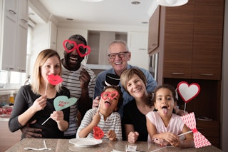 A family laughs and takes funny pictures on Valentine's Day.