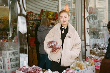 Zoey Gong in front of a shop
