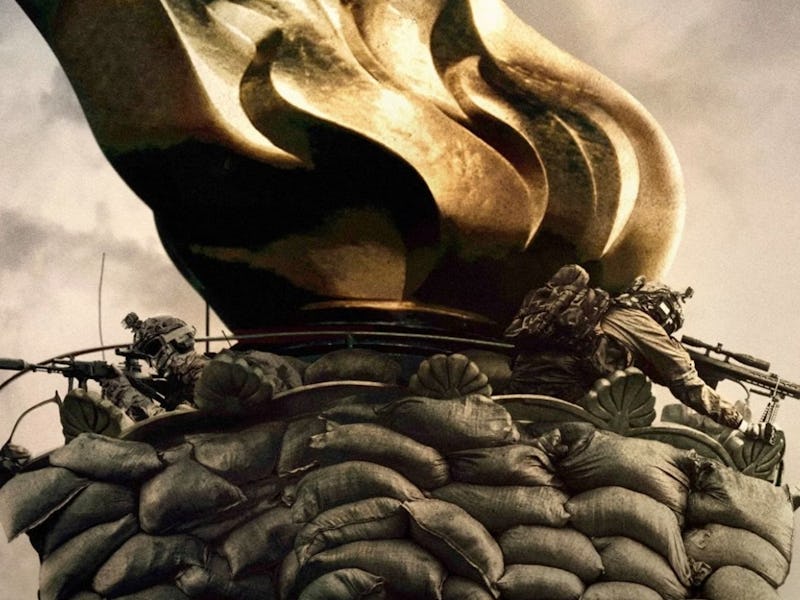 Giant golden torch with a sculpted flame, surrounded by a wreath, with soldiers in camouflage climbi...