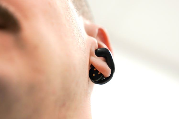 Bose Ultra Open Earbuds in Inverse Senior Editor James Pero's ears.