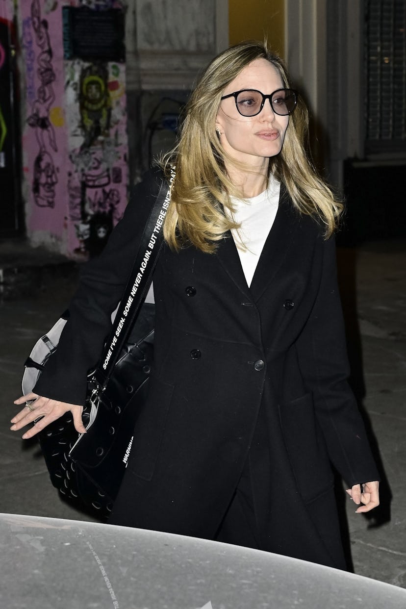 Angelina Jolie off-duty outfit with a wool coat and graphic tote bag