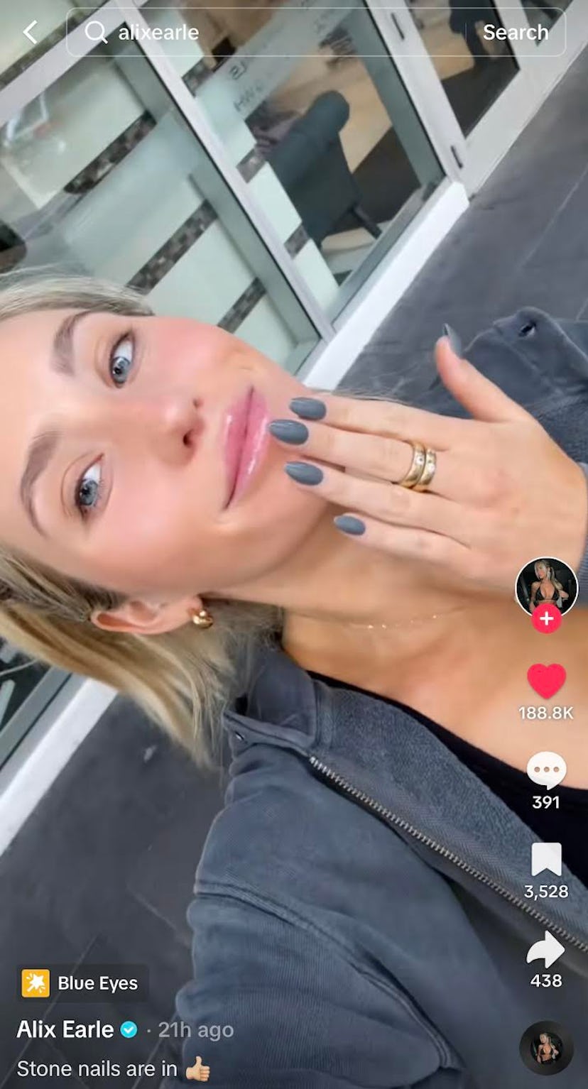 Alix Earle painted her nails a stone gray color.