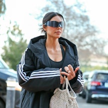 kim kardashian carries a crystal net mesh bag from ballenciaga