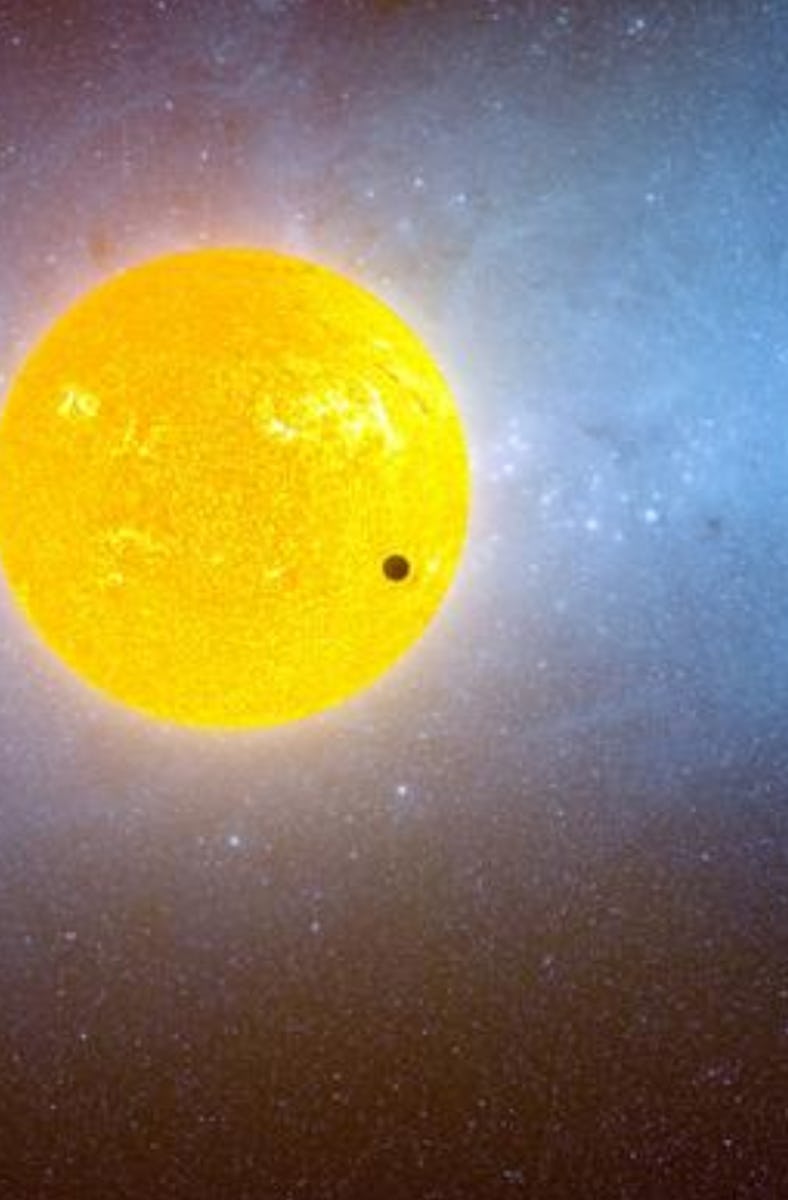 An artistic rendition of an exoplanet transit with a large, dark planet silhouetted against a glowin...