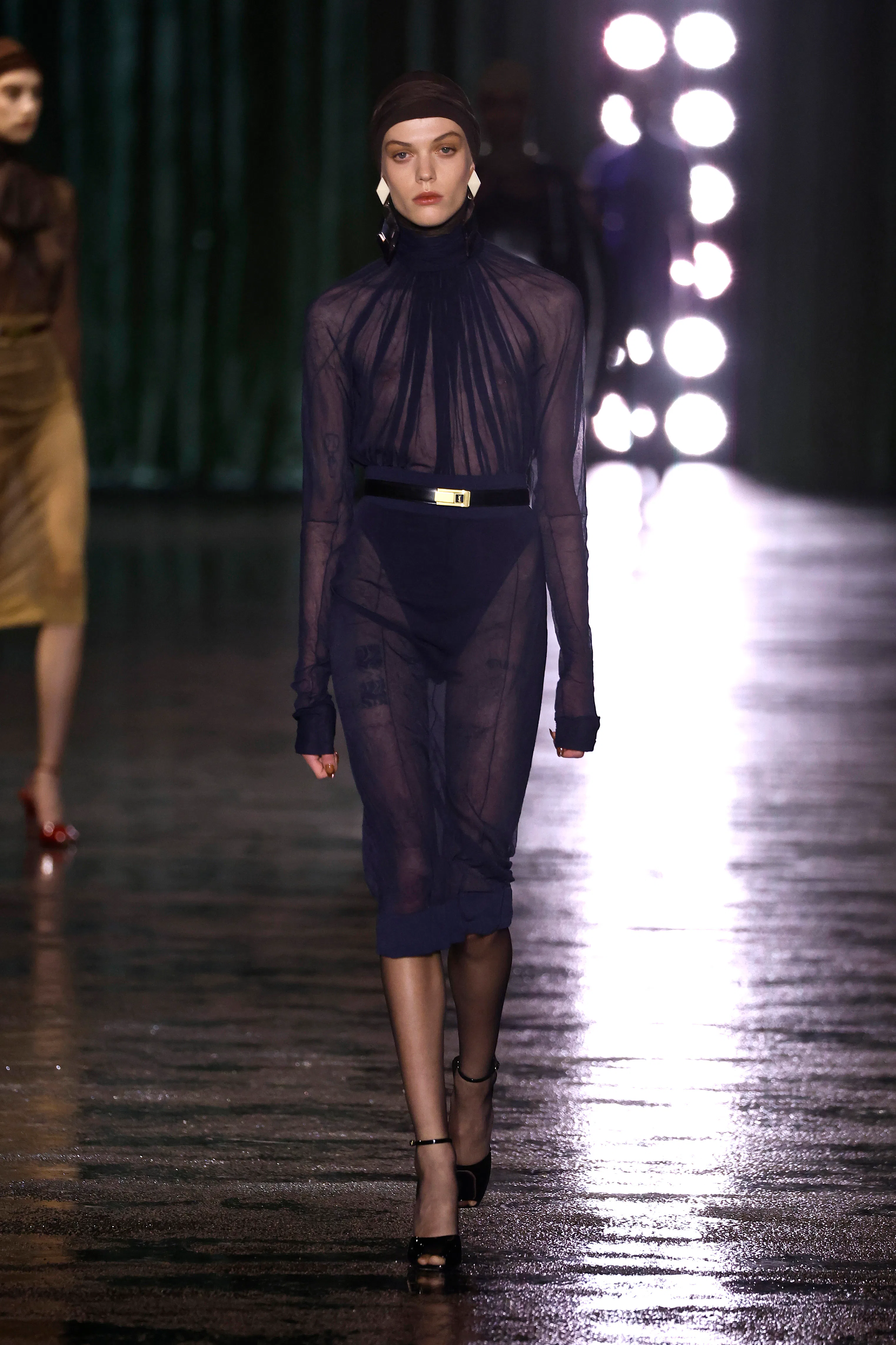 Bir model, Saint Laurent Kadın Giyim Sonbahar/Kış 2024-2025 defilesi sırasında podyumda yürüyor.