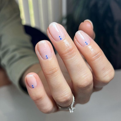 Neutral nails with blue dot details are on-trend.