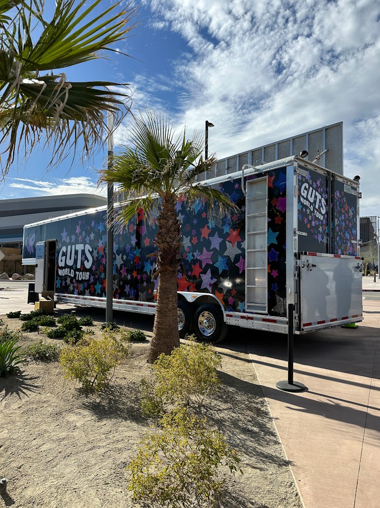 There are merch trucks for the 'GUTS' World Tour outside the venue. 