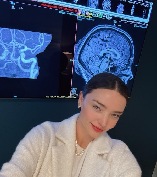 Miranda Kerr poses by her scans.