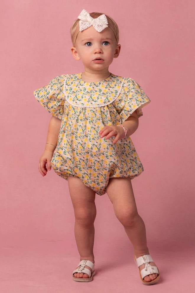Yellow floral baby romper, a more formal easter 2024 outfit for kids.
