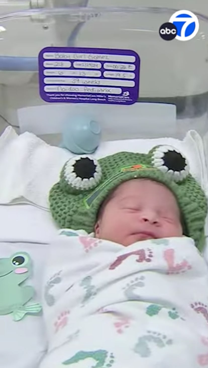 Baby Girl Gomez, born on Leap Day wearing a frog hat.