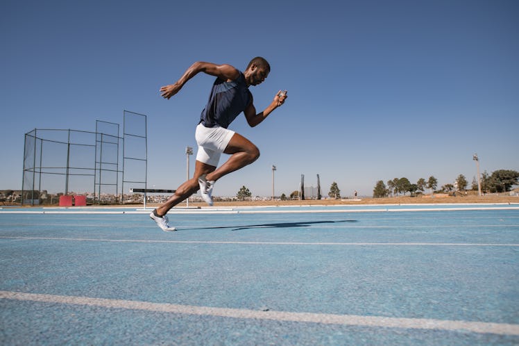 A man running on a track, doing the Beep Test.