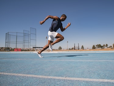 A man running on a track, doing the Beep Test.