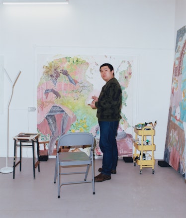 Ding Shilun standing in his studio