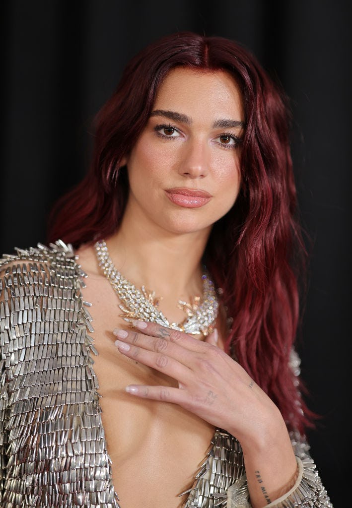 Dua Lipa at the 2024 Grammys with sheer nails.