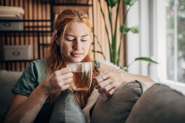 A woman sips on spearmint tea.