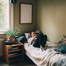 A teen girl relaxes in her bedroom.