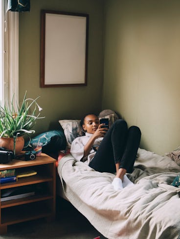 A teen girl relaxes in her bedroom.
