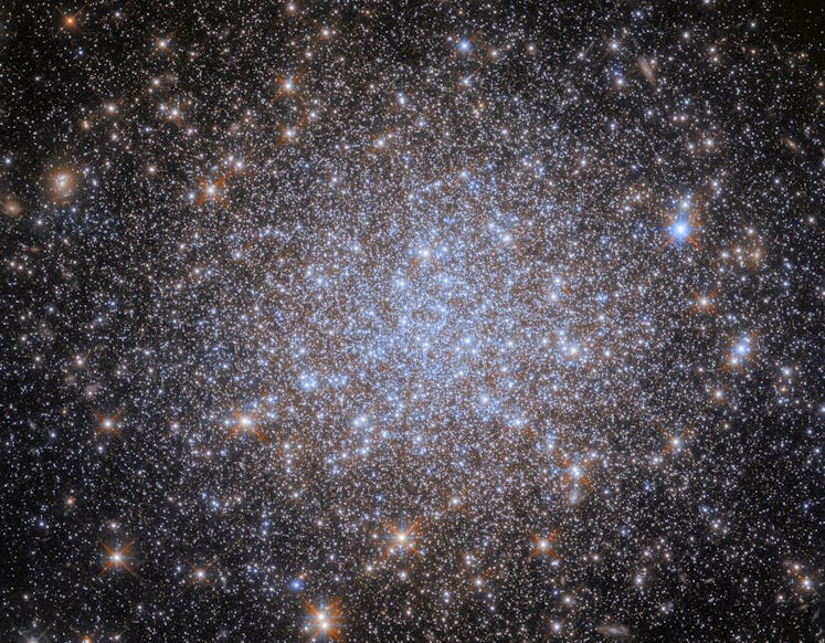 A cluster of stars. Most of the stars are very small and uniform in size, and they are notably bluis...