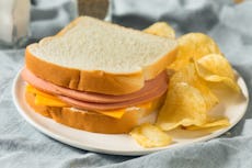 A bologna sandwich with chips.
