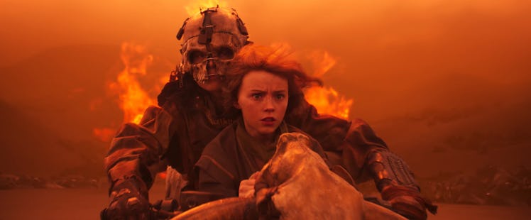 Furiosa (Anya Taylor-Joy) rescues a young girl in Furiosa: A Mad Max Saga