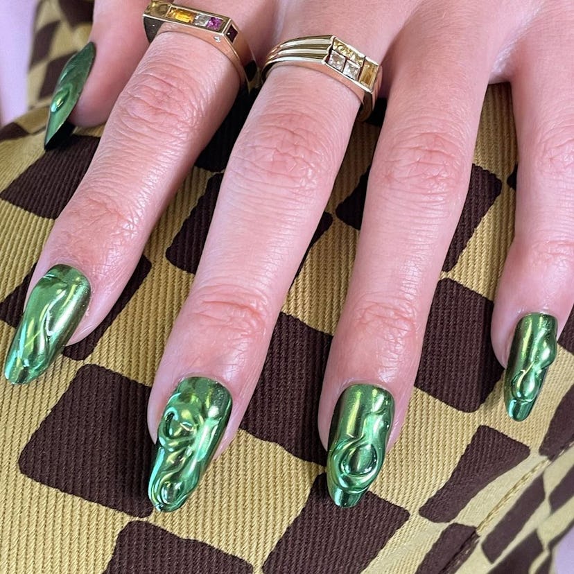 Green chrome nails will trend for spring 2024.
