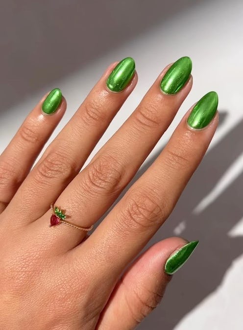 Green chrome nails are trending for spring 2024.
