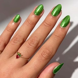 Green chrome nails are trending for spring 2024.