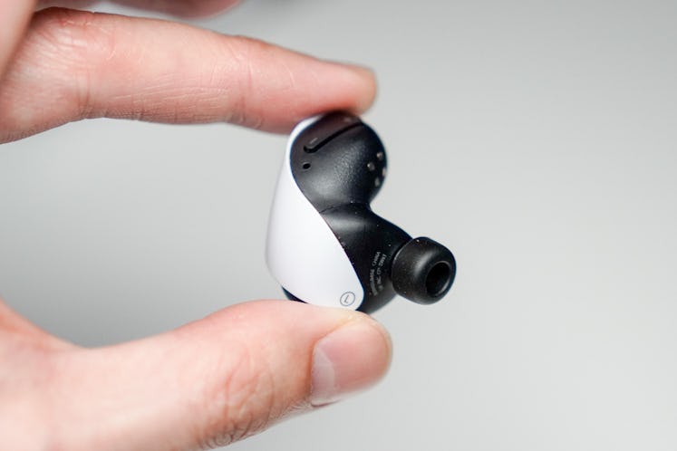 The insides of the PlayStatio Pulse Explore wireless earbuds have tiny little PlayStation symbols