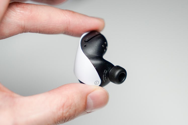 The insides of the PlayStatio Pulse Explore wireless earbuds have tiny little PlayStation symbols
