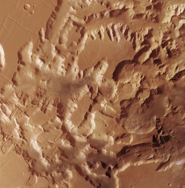 Aerial view of a rugged, textured Martian landscape with undulating terrain and crater impacts.