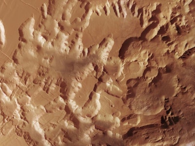 Aerial view of a rugged, textured Martian landscape with undulating terrain and crater impacts.