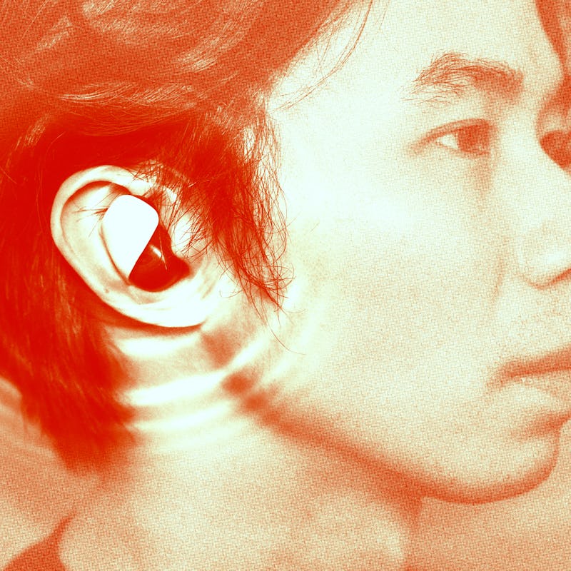 Side profile of a person with an earbud, with a reddish-orange tinted overlay.