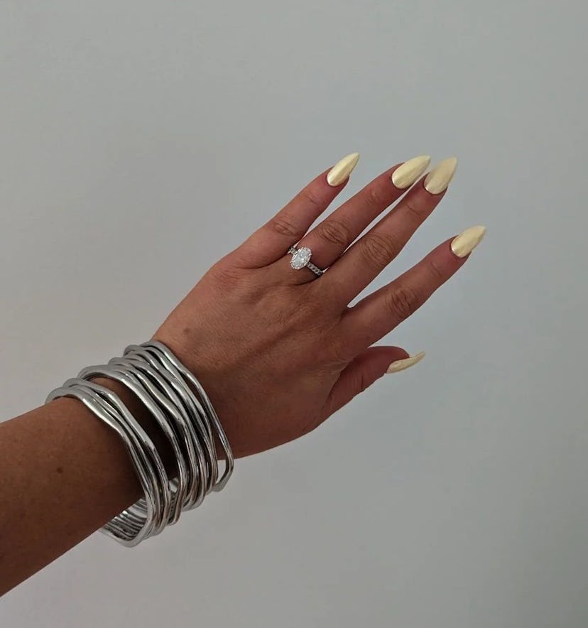 Butter yellow chrome nails are on-trend for spring 2024.
