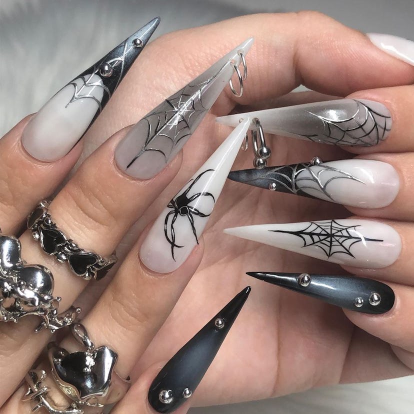 Stiletto nails with spider-inspired designs match the "grunge girl" aesthetic.