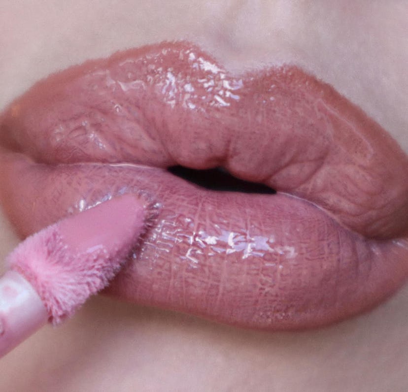 Olivia Rose Rushing wears the Huda Beauty Faux Filler Shiny Non-Sticky Lip Gloss in the shade Sugar ...