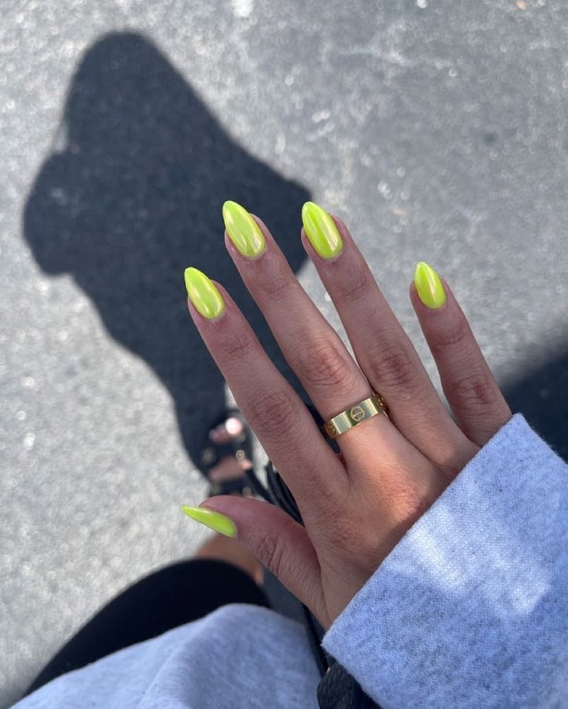 Neon yellow chrome nails are on-trend for spring 2024.