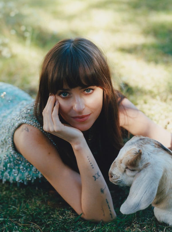 Dakota Johnson in a green Gucci dress with a baby goat.