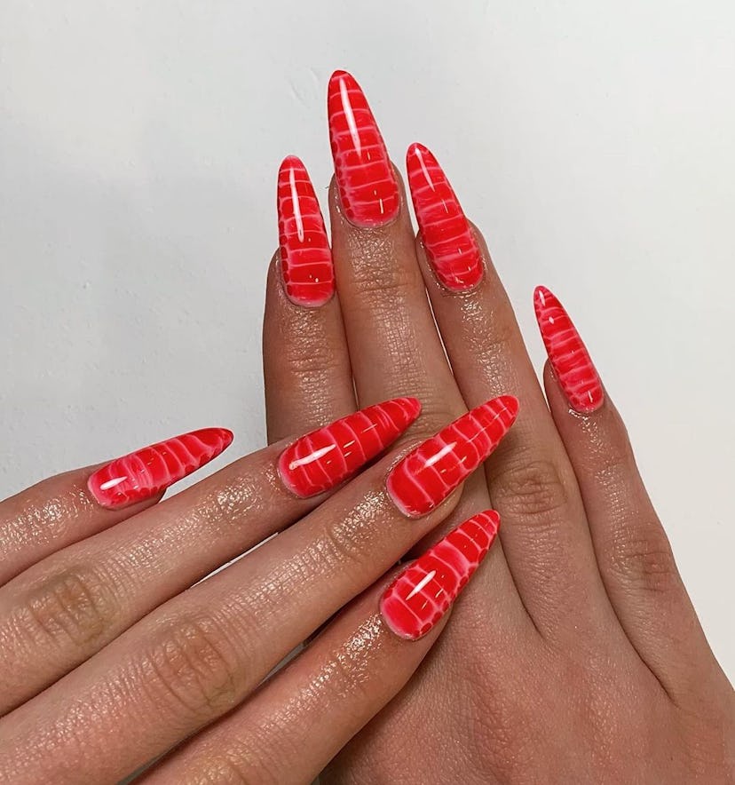 Fire-red croc print manicures are trending for Aries season 2024.