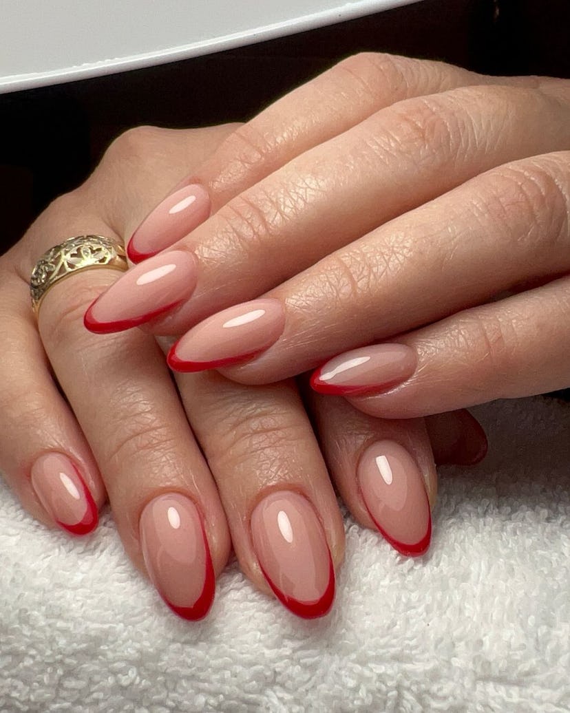 Red micro French tip nails are trending for Aries season 2024.