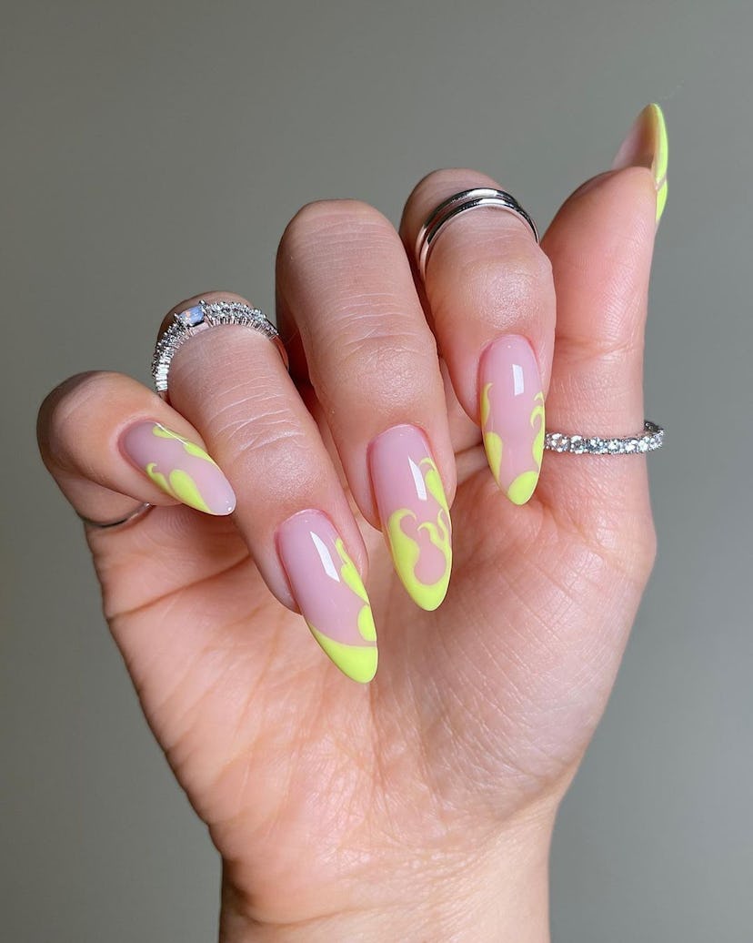 Abstract neon yellow flame nail art designs are trending for Aries season 2024.