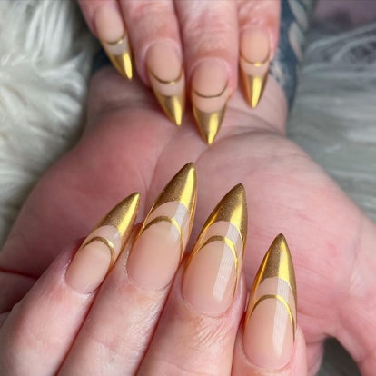 Gold chrome double-lined French tip nails are on-trend for summer 2024.
