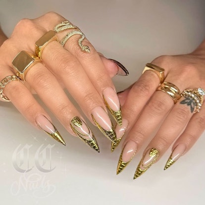Gold chrome croc print French tip nails are on-trend for summer 2024.